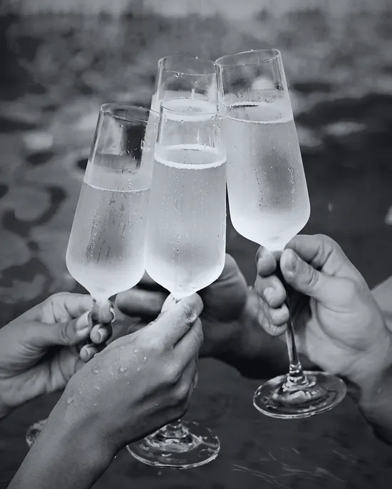 Champagne glasses raised in a toast